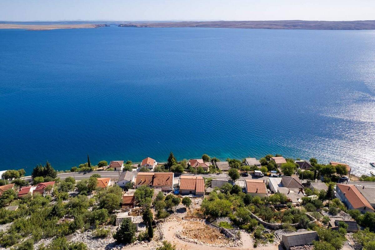 A coastal village with houses and a clear view of the sea.
