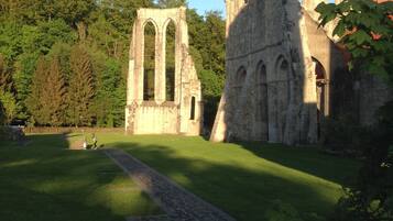 A historic stone structure with arched windows and a pathway leading to it.