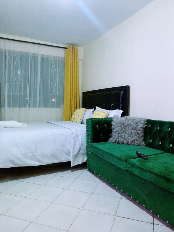 Business Studio | Living area | 14-inch Smart TV with digital channels, TV - Stay.Plus Hill View Studio Apartment (Nairobi)