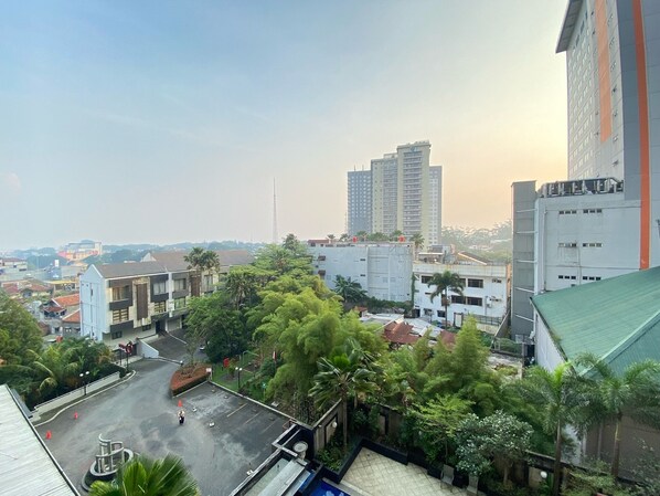 A high-rise building with a modern design, surrounded by greenery and other residential buildings. - Cozy 2Br At Galeri Ciumbuleuit 1 Apartment (Bandung)