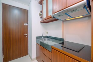 Fridge, stovetop, cookware/dishes/utensils, dining tables - Fancy And Nice Studio Apartment At Transpark Cibubur (Depok)
