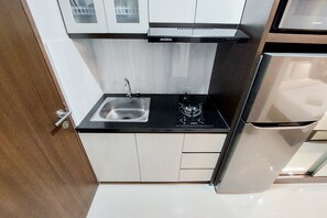 Fridge, stovetop, cookware/dishes/utensils, dining tables - Fancy And Nice Studio At Transpark Bintaro Apartment (South Tangerang)