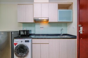 Fridge, stovetop, cookware/dishes/utensils, dining tables - Nice And Cozy Studio At Menteng Park Apartment (Jakarta)