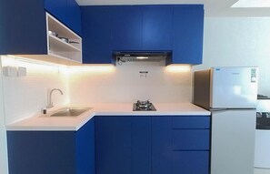 Fridge, stovetop, cookware/dishes/utensils, dining tables - Comfort And Warm Studio Room At Amethyst Kemayoran Apartment (Jakarta)