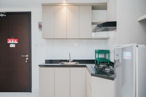 Fridge, stovetop, cookware/dishes/utensils, dining tables - Comfort And Simple 1Br At Casa De Parco Apartment (South Tangerang)