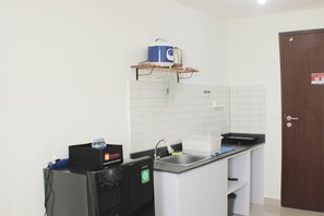 Fridge, stovetop, cookware/dishes/utensils, dining tables - Fancy And Nice Studio Apartment At Sayana Bekasi (Bekasi)