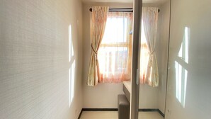 A room with a bench, a window with curtains, and a door. - Cozy And Serene 2Br Apartment At Parahyangan Residence (Bandung)