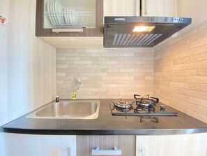 Fridge, stovetop, cookware/dishes/utensils, dining tables - Cozy And Serene 2Br Apartment At Parahyangan Residence (Bandung)