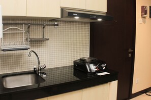 Fridge, stovetop, cookware/dishes/utensils, dining tables - Comfort 1Br At Sky Terrace Apartment (Jakarta)