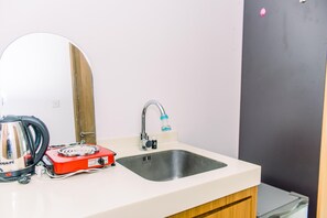 Fridge, stovetop, cookware/dishes/utensils, dining tables - Fancy And Nice Studio At Tree Park City Cikokol Apartment (Tangerang)