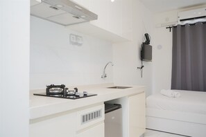 Fridge, stovetop, cookware/dishes/utensils, dining tables - Comfy And Cozy Stay Studio Room At Sky House Bsd Apartment (Pagedangan)