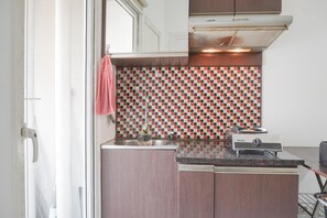 Fridge, stovetop, cookware/dishes/utensils, dining tables - Best Deal And Comfy 2Br At Green Pramuka City Apartment (Jakarta)