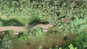 An aerial view of a park with a paved walkway, benches, and various green areas. - Best Deal And Comfy 2Br At Green Pramuka City Apartment (Jakarta)