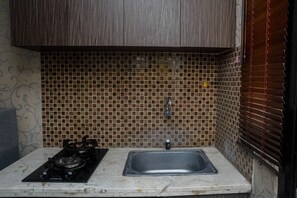 Fridge, stovetop, cookware/dishes/utensils, dining tables - Comfort Studio Room At Kebagusan City Apartment (Jakarta)