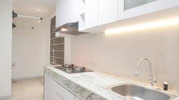 Fridge, stovetop, cookware/dishes/utensils, dining tables