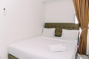 Restful retreat with a neatly made bed and clean, minimalist design.