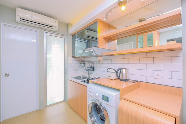 Fridge, stovetop, cookware/dishes/utensils, dining tables - Big And Cozy 1Br Bassura City Apartment Near Mall (Jakarta)