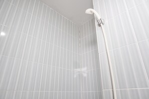 A bathroom with white tiled walls and a shower area. - Nice And Cozy 2Br At Cinere Resort Apartment (Depok)