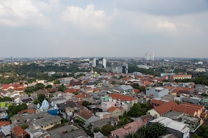 A densely packed urban area with a variety of building styles, including residential and commercial structures. - Minimalist 1Br Apartment With Pool View At Atlanta Residences (Depok)