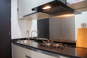 Fridge, stovetop, cookware/dishes/utensils, dining tables - Minimalist 1Br Apartment With Pool View At Atlanta Residences (Depok)