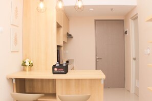 Fridge, stovetop, cookware/dishes/utensils, dining tables - Cozy And Elegant 1Br Vasanta Innopark Apartment (Cikarang)