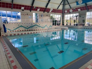 Relax by the pool surrounded by lush greenery and natural light.