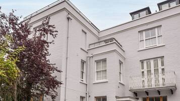 A white building with multiple windows and a balcony.