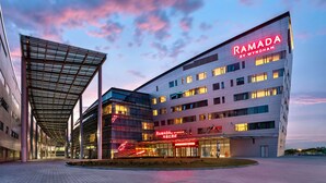 A modern building with the sign "RAMADA BY WYNDHAM" prominently displayed. - Ramada By Wyndham Huzhou Wuxing (Huzhou)