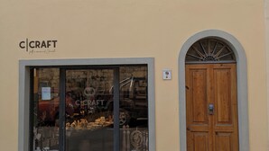 A storefront with a large glass window displaying various items.