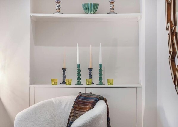 A white cabinet with a shelf containing candles and glassware. - Miss Westside Story - by Out of Office Lifestyle (Greater London)