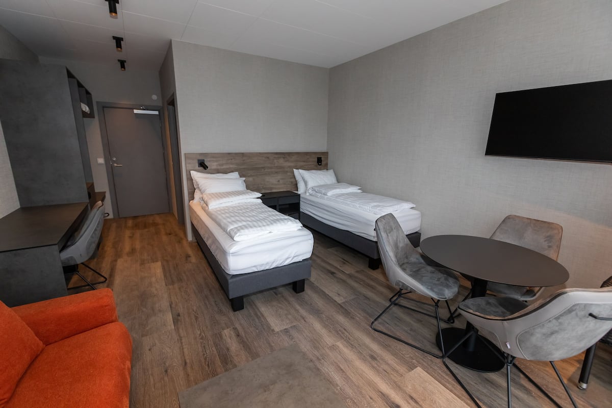 Ropa de cama hipoalergénica y caja de seguridad en la habitación