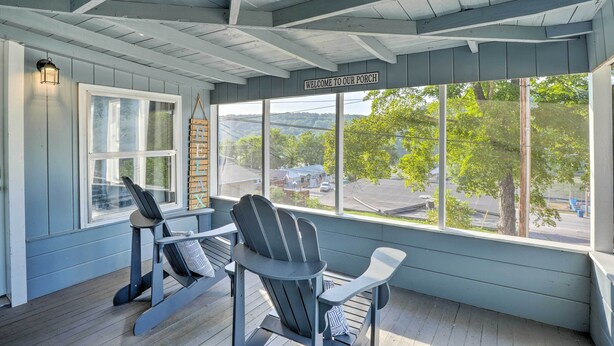 A porch with two Adirondack chairs, a wooden ladder, and a 'Welcome to our Porch' sign. - 11 Mi to Dtwn Branson: Cottage in Rockaway Beach! (Rockaway Beach)
