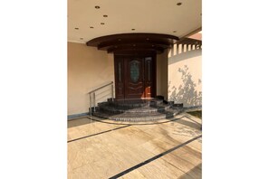Stunning entrance with a grand staircase and beautifully designed door.