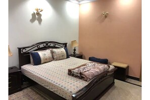 Cozy retreat with a single bed, two bedside tables, and lamps.