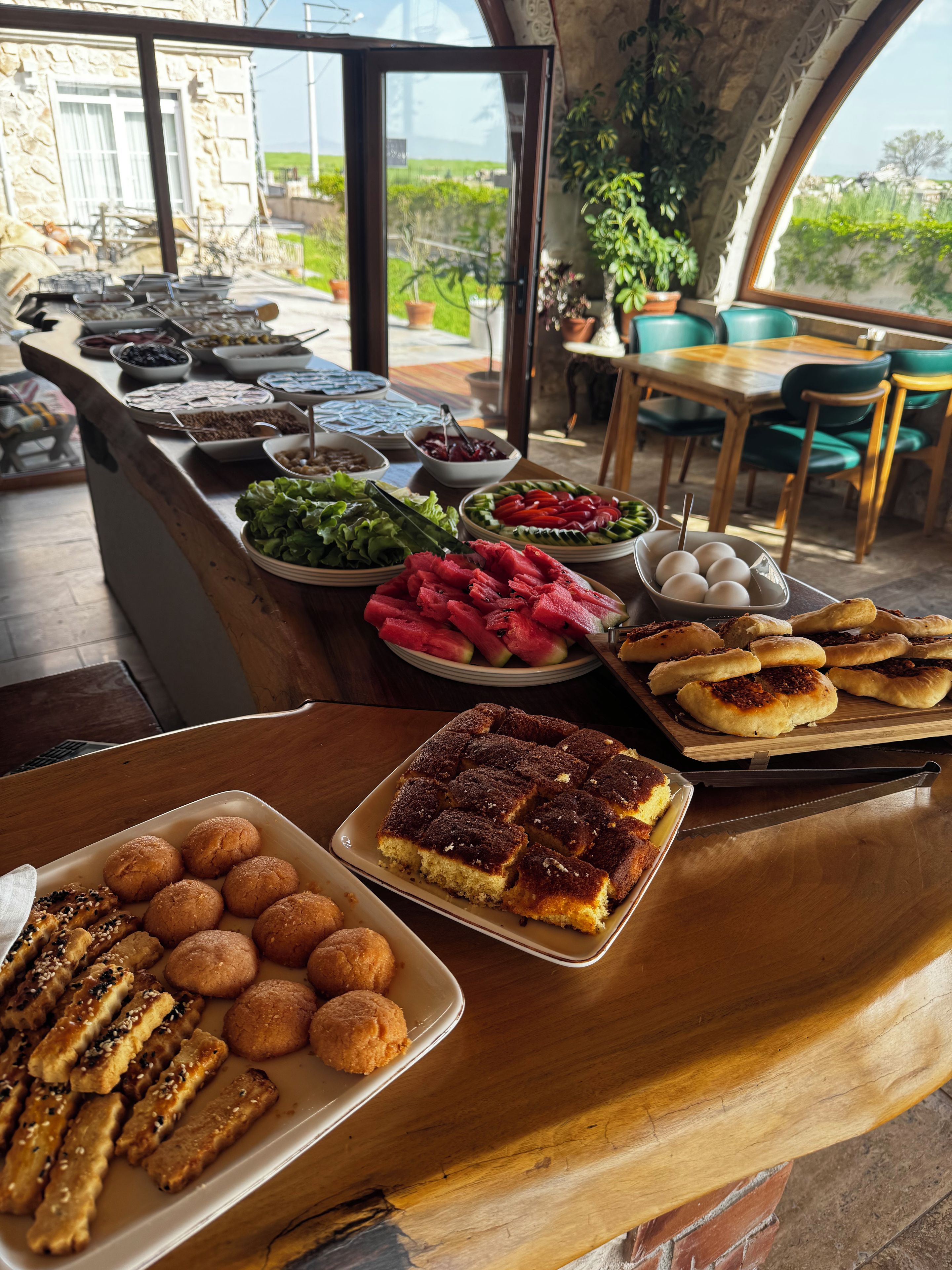 A buffet with various dishes including bread, salads, and desserts.