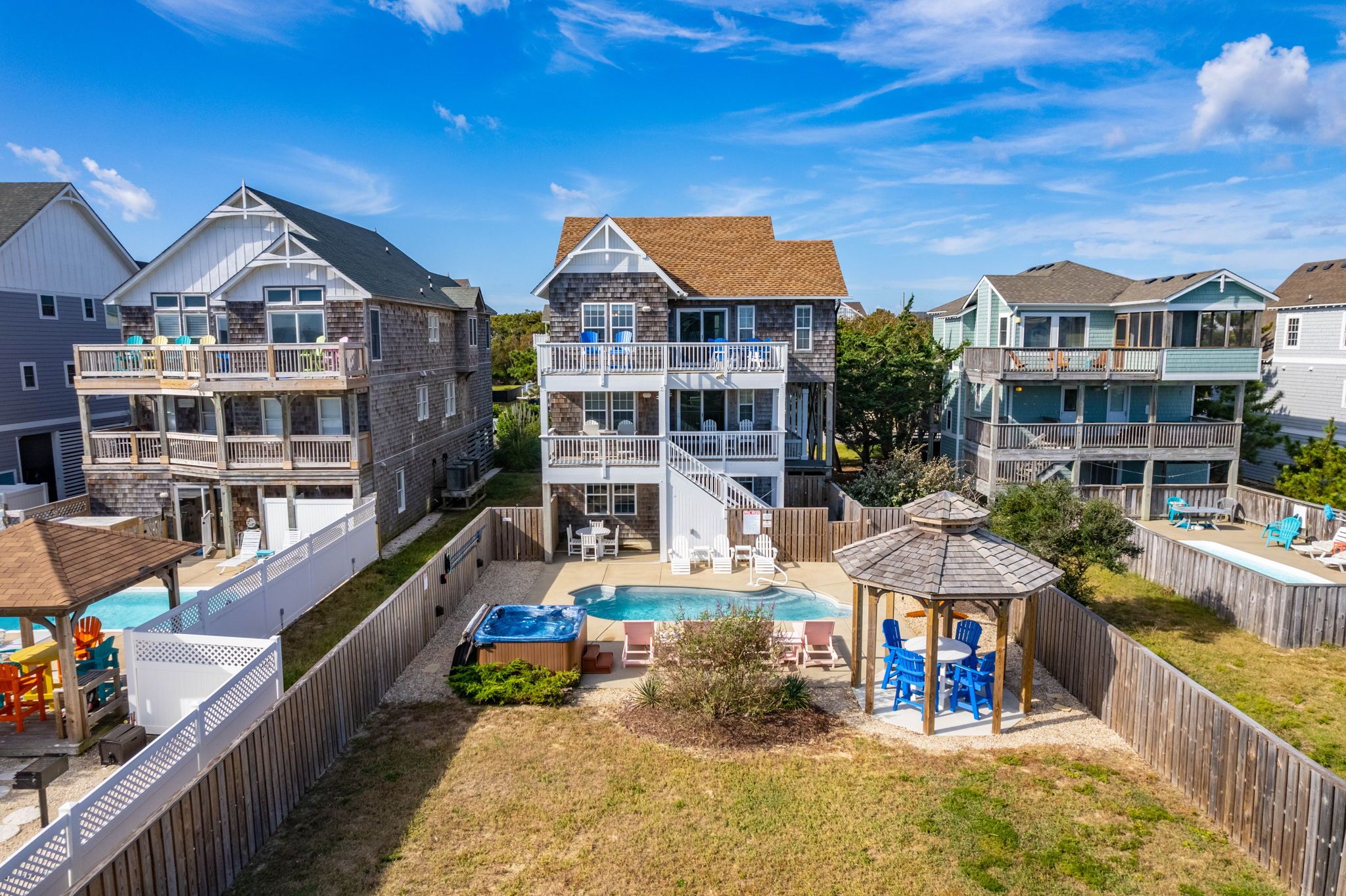 A residential area with multiple two-story houses, a swimming pool, and a gazebo.