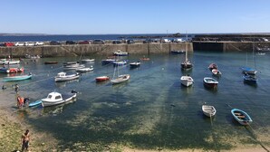 A harbor with various boats docked at the pier. - A stunning Cornish barn, ideally located for visiting the North and South Coast. (Altarnun)