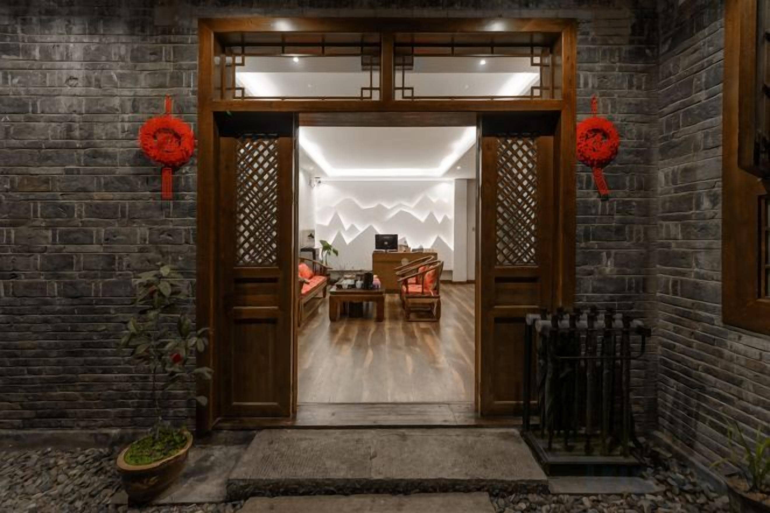 A traditional wooden entrance with a modern interior visible through the doorway.