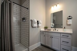 1 Bedroom Suite, Main St View, Room 9 | Bathroom | Shower, hair dryer, towels, soap