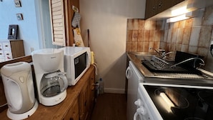 A compact kitchen with a microwave, coffee maker, and a stove. - VIKING 23 - Village center apartment - Parking (La Clusaz)