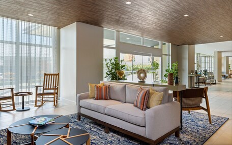A spacious living area with a sofa, chairs, and a coffee table.