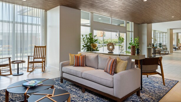 A spacious living area with a sofa, chairs, and a coffee table. - Fairfield by Marriott San Jose Airport Alajuela (Rio Segundo)