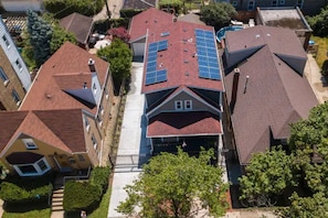 A residential area with houses featuring red roofs and solar panels.
