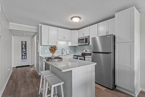 Enjoy cooking in this well-lit kitchen with a central island, microwave, and oven.