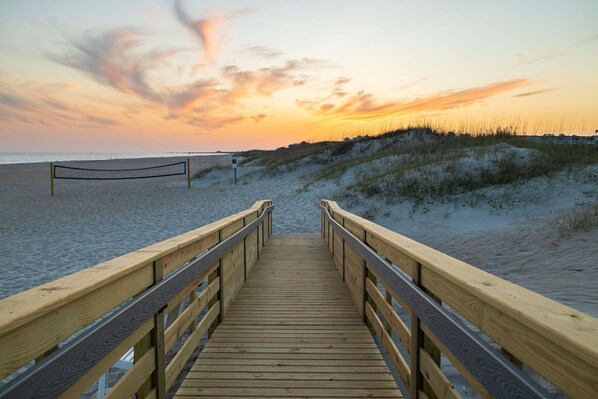 Walk along the boardwalk to the sandy beach, where a volleyball net awaits.