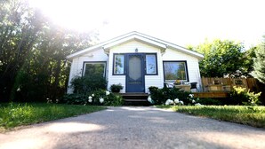 A single-story house with a front porch, a mailbox, and a number '5024' on the door.