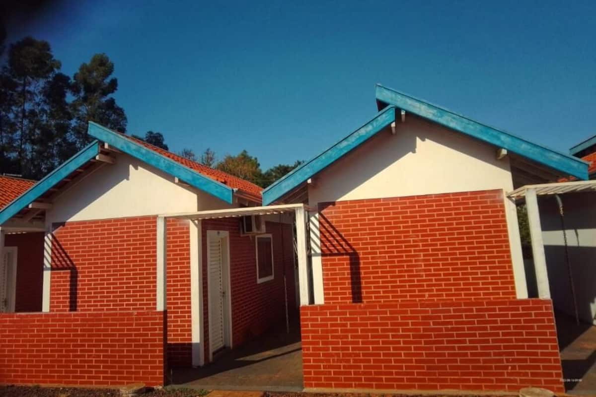 A row of brick buildings with blue roofs and white trim, likely part of a residential or hotel complex.