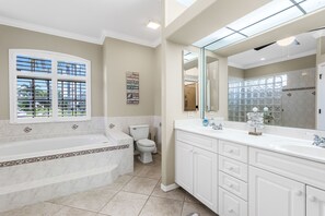Bathtub, hair dryer, towels, toilet paper