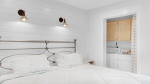 A neatly made bed with a metal headboard, two bedside lamps, and a small bedside table with a lamp. -   ⭐1st Floor-Walk2Beach-Community Pool-1BR Shoeless Joe⭐ (Miramar Beach)