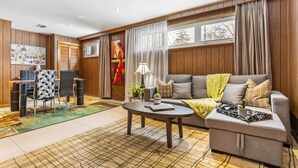 A modern living room with a sofa, coffee table, and dining area. - Cosy Spacious 3+2 bedroom house , one bus to subway station (Toronto)